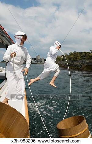Stock Photograph - female divers gathering oysters shinjuto island, where Mr Mikimoto started growing white pearls shinju in japanese City of Toba, National Park of Ise-Shima, Mie prefecture Japan. Fotosearch