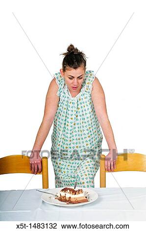 Female eating disorder Young woman craves a cream cake late at night She is alone and overeating when no one can detect her View Large Photo Image Stock Image - Female eating disorder Young woman craves a cream cake late at night She is alone and overeating when no one can detect her. Fotosearch