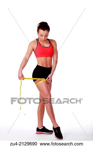 Female fitness model measuring volumes. View Large Photo Image Stock Image - Female fitness model measuring volumes.. Fotosearch