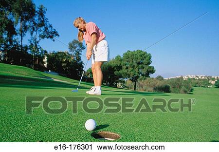 Female golfer putting View Large Photo Image Stock Image - Female golfer putting. Fotosearch