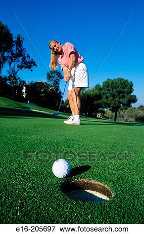 Female golfer putting View Large Photo Image Stock Photo - Female golfer putting. Fotosearch