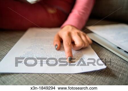 Female hand pointing to text on page View Large Photo Image Picture - Female hand pointing to text on page. Fotosearch