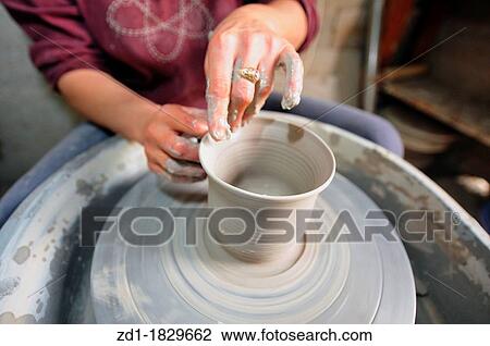 Female hands making pottery on spinning wheel View Large Photo Image Stock Image - Female hands making pottery on spinning wheel. Fotosearch