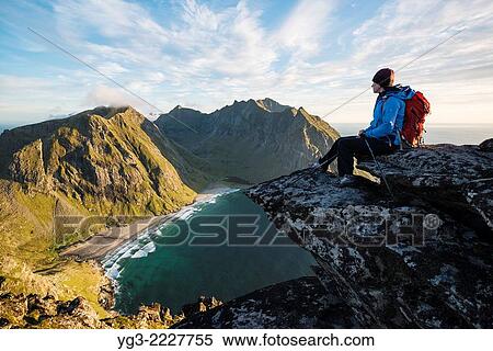 Female hiker enjoying view of Kvalvika beach from near summit of Ryten, Moskenesoy, Lofoten Islands, Norway. View Large Photo Image Stock Photography - Female hiker enjoying view of Kvalvika beach from near summit of Ryten, Moskenesoy, Lofoten Islands, Norway.. Fotosearch