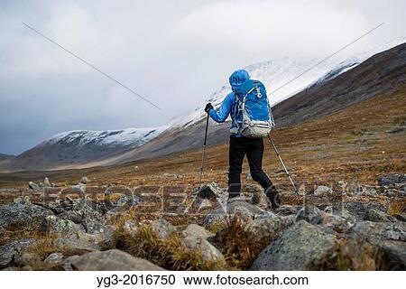 Female hiker hikes over rocky terrain in Tj? ktjavagge on Kungsleden trail, Lappland, Sweden. View Large Photo Image Stock Image - Female hiker hikes over rocky terrain in Tj? ktjavagge on Kungsleden trail, Lappland, Sweden.. Fotosearch
