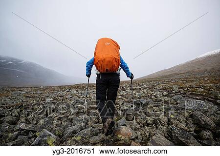 Female hiker hikes over rocky terrain in Tj? ktjavagge on Kungsleden trail, Lappland, Sweden. View Large Photo Image Stock Image - Female hiker hikes over rocky terrain in Tj? ktjavagge on Kungsleden trail, Lappland, Sweden.. Fotosearch