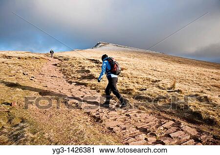 Female hiker hiking on mountain path to Corn Du, Brecon Beacons national park, Wales View Large Photo Image Stock Image - Female hiker hiking on mountain path to Corn Du, Brecon Beacons national park, Wales. Fotosearch