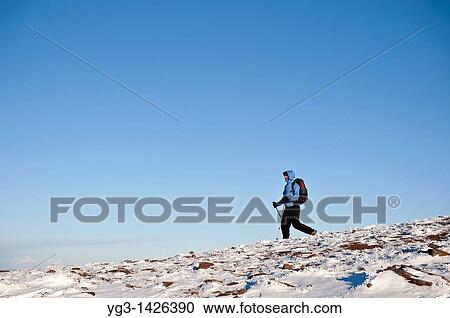 Female hiker hiking on snowy mountain terrain, Brecon Beacons national park, Wales View Large Photo Image Stock Image - Female hiker hiking on snowy mountain terrain, Brecon Beacons national park, Wales. Fotosearch