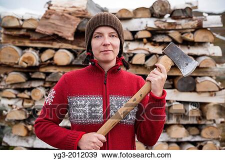 Female hiker in nordic style sweater holding axe to cut firewood at mountain hut, Kungsleden trail, Lappland, Sweden. View Large Photo Image Stock Photo - Female hiker in nordic style sweater holding axe to cut firewood at mountain hut, Kungsleden trail, Lappland, Sweden.. Fotosearch