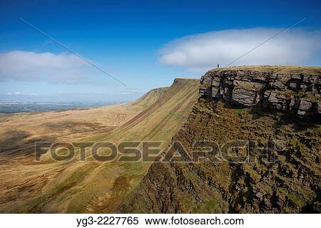 Female hiker on Carmarthen Fans - Bannau Sir Gaer with Picws Du in distance, Black Mountain, Brecon Beacons national park, Wales. View Large Photo Image Stock Photography - Female hiker on Carmarthen Fans - Bannau Sir Gaer with Picws Du in distance, Black Mountain, Brecon Beacons national park, Wales.. Fotosearch
