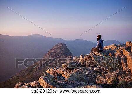 Female hiker on summit of Glyder Fach with Tryfan in background, Snowdonia national park, Wales. View Large Photo Image Stock Photo - Female hiker on summit of Glyder Fach with Tryfan in background, Snowdonia national park, Wales.. Fotosearch