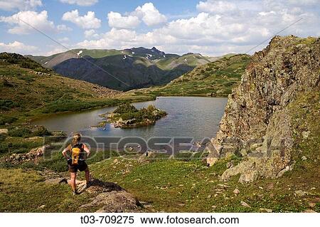 Female hiker pauses to take in the view above Highland Mary Lakes in the Weminuche Wilderness, San Juan Mountains, Colorado, USA View Large Photo Image Stock Photography - Female hiker pauses to take in the view above Highland Mary Lakes in the Weminuche Wilderness, San Juan Mountains, Colorado, USA. Fotosearch