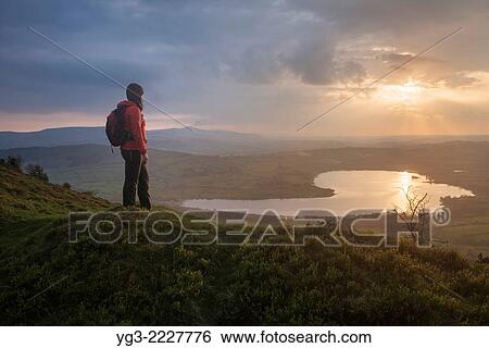 Female hiker takes in view of Llangorse lake from Mynydd Llangorse, Brecon Beacons national park, Wales. View Large Photo Image Stock Photograph - Female hiker takes in view of Llangorse lake from Mynydd Llangorse, Brecon Beacons national park, Wales.. Fotosearch