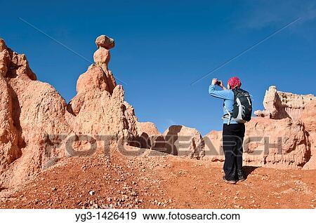 Female hiker takes photo of Hoodoo formations from Queens Garden trail, Bryce Canyon national park, Utah, USA View Large Photo Image Stock Photo - Female hiker takes photo of Hoodoo formations from Queens Garden trail, Bryce Canyon national park, Utah, USA. Fotosearch