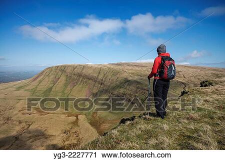 Female hill walker hiking on summit of Picws Du with Fan Brycheiniog in distance, Black Mountain, Brecon Beacons national park, Wales. View Large Photo Image Stock Image - Female hill walker hiking on summit of Picws Du with Fan Brycheiniog in distance, Black Mountain, Brecon Beacons national park, Wales.. Fotosearch