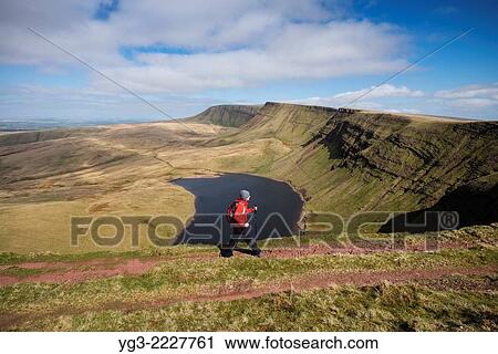 Female hill walker hiking towards Waun Lefrith above Llyn Y Fan Fach, Black Mountain, Brecon Beacons national park, Wales. View Large Photo Image Stock Image - Female hill walker hiking towards Waun Lefrith above Llyn Y Fan Fach, Black Mountain, Brecon Beacons national park, Wales.. Fotosearch