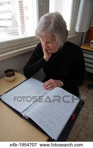 Female in her early 70s doing paperwork Pori Finland Europe. View Large Photo Image Stock Photo - Female in her early 70s doing paperwork Pori Finland Europe.. Fotosearch