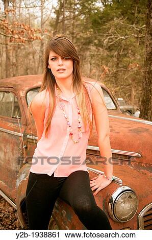 Female model by antique red automobile View Large Photo Image Stock Image - Female model by antique red automobile. Fotosearch