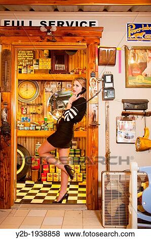 Female model in vintage service station View Large Photo Image Stock Photo - Female model in vintage service station. Fotosearch