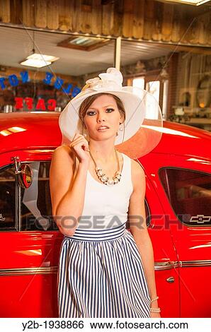 Female model in wide-brimmed white hat by antique red automobile View Large Photo Image Stock Photograph - Female model in wide-brimmed white hat by antique red automobile. Fotosearch