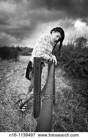 Female model leaning on rail View Large Photo Image Stock Photo - Female model leaning on rail. Fotosearch
