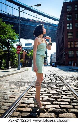 Female model posing on streets of New York. Manhattan bridge. USA. View Large Photo Image Picture - Female model posing on streets of New York. Manhattan bridge. USA.. Fotosearch