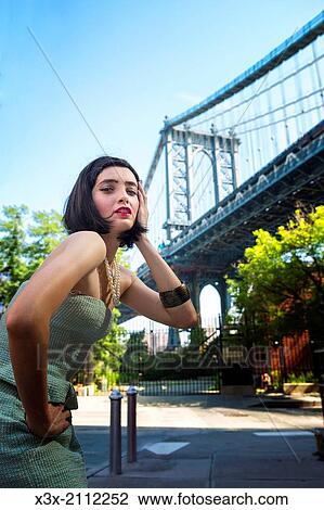 Female model posing on streets of New York. Manhattan bridge. USA. View Large Photo Image Stock Image - Female model posing on streets of New York. Manhattan bridge. USA.. Fotosearch
