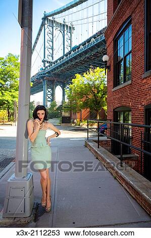 Female model posing on streets of New York. Manhattan bridge. USA. View Large Photo Image Stock Image - Female model posing on streets of New York. Manhattan bridge. USA.. Fotosearch