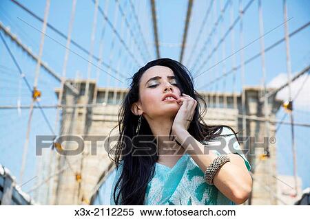 Female model posing on streets of New York. Brooklyn bridge. USA. View Large Photo Image Stock Photography - Female model posing on streets of New York. Brooklyn bridge. USA.. Fotosearch