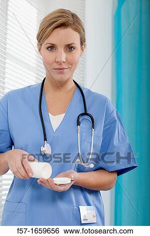 Female Nurse dispensing medicine View Large Photo Image Stock Photograph - Female Nurse dispensing medicine. Fotosearch