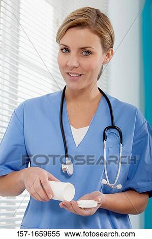 Female Nurse dispensing medicine View Large Photo Image Stock Photography - Female Nurse dispensing medicine. Fotosearch