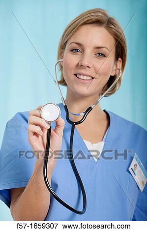 Stock Photo - Female Nurse holding up her stethoscope. Fotosearch