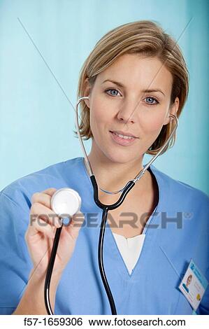 Female Nurse holding up her stethoscope View Large Photo Image Stock Photograph - Female Nurse holding up her stethoscope. Fotosearch