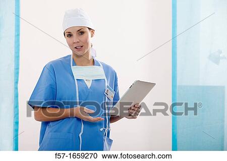 Female Nurse reviewing medical records on a tablet computer View Large Photo Image Stock Image - Female Nurse reviewing medical records on a tablet computer. Fotosearch