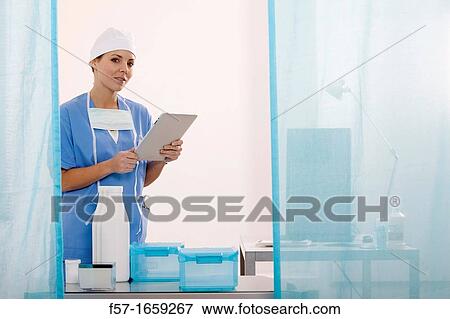 Female Nurse reviewing medical records on a tablet computer View Large Photo Image Stock Photo - Female Nurse reviewing medical records on a tablet computer. Fotosearch