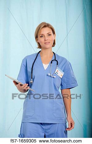 Female Nurse reviewing medical records on a tablet computer View Large Photo Image Stock Photography - Female Nurse reviewing medical records on a tablet computer. Fotosearch