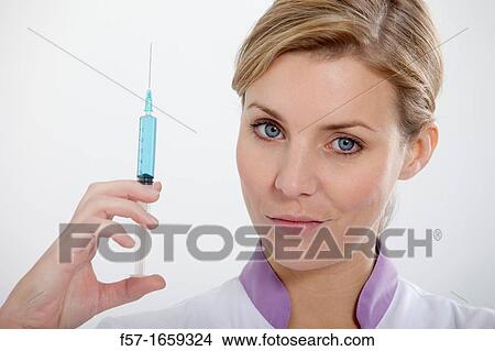 Female Nurse with a syringe View Large Photo Image Picture - Female Nurse with a syringe. Fotosearch