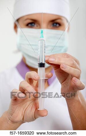 Female Nurse with a syringe View Large Photo Image Stock Image - Female Nurse with a syringe. Fotosearch