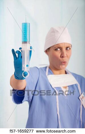 Female Nurse with a syringe View Large Photo Image Stock Photo - Female Nurse with a syringe. Fotosearch
