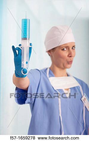 Female Nurse with a syringe View Large Photo Image Stock Photo - Female Nurse with a syringe. Fotosearch
