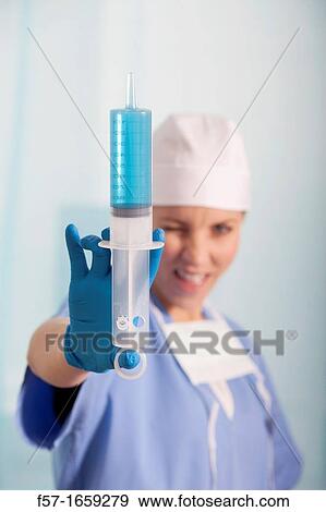 Female Nurse with a syringe View Large Photo Image Stock Photo - Female Nurse with a syringe. Fotosearch