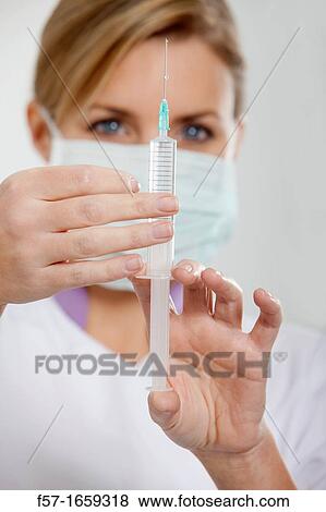 Female Nurse with a syringe View Large Photo Image Stock Photo - Female Nurse with a syringe. Fotosearch
