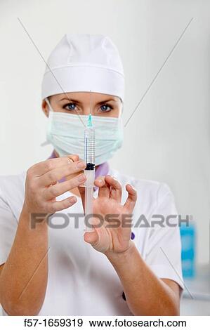 Stock Photo - Female Nurse with a syringe. Fotosearch