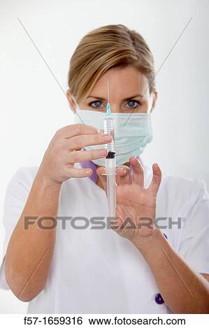 Female Nurse with a syringe View Large Photo Image Stock Photograph - Female Nurse with a syringe. Fotosearch