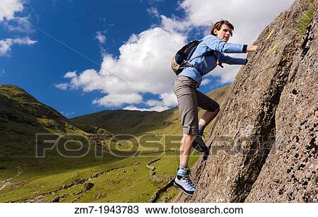 Female rock scrambler climbing up Seathwaite Slabs, Lake District, UK. View Large Photo Image Stock Image - Female rock scrambler climbing up Seathwaite Slabs, Lake District, UK.. Fotosearch