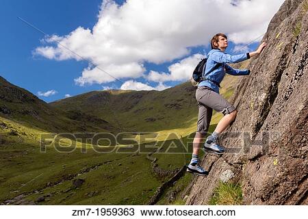 Female rock scrambler climbing up Seathwaite Slabs, Lake District, UK. View Large Photo Image Stock Image - Female rock scrambler climbing up Seathwaite Slabs, Lake District, UK.. Fotosearch