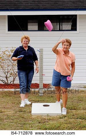 Female Senior retired citizens play game of bean bag toss in a recreational vechile camping park in Bonita Springs Florida View Large Photo Image Stock Photo - Female Senior retired citizens play game of bean bag toss in a recreational vechile camping park in Bonita Springs Florida. Fotosearch