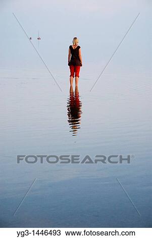 Female standing in shallow water of German Wadden Sea, Juist, Lower Saxony, Germany View Large Photo Image Stock Image - Female standing in shallow water of German Wadden Sea, Juist, Lower Saxony, Germany. Fotosearch