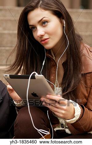 Female student studying lecture from her ipad using iTunes U application View Large Photo Image Stock Image - Female student studying lecture from her ipad using iTunes U application. Fotosearch
