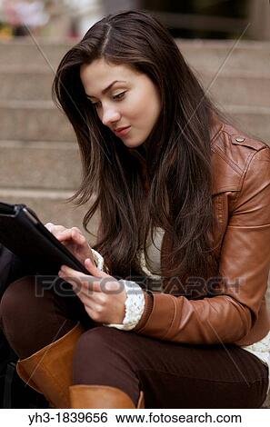 Female student studying university course from her digital tablet View Large Photo Image Stock Photograph - Female student studying university course from her digital tablet. Fotosearch